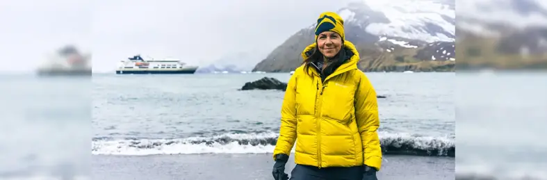 Julia Bradbury with snow-capped mountains and an HX vessel in the back