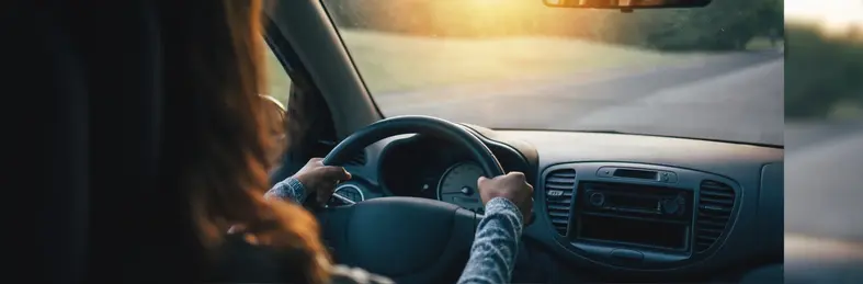 A woman driving a car.