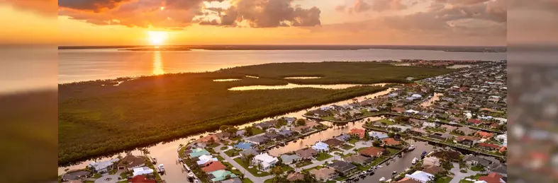 Evening glow over Punta Gorda, Florida. Waterfront with luxurious houses, palm trees and peaceful suburban atmosphere.