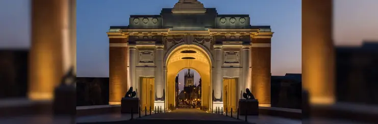 A photo of Menin Gate lit up at night.