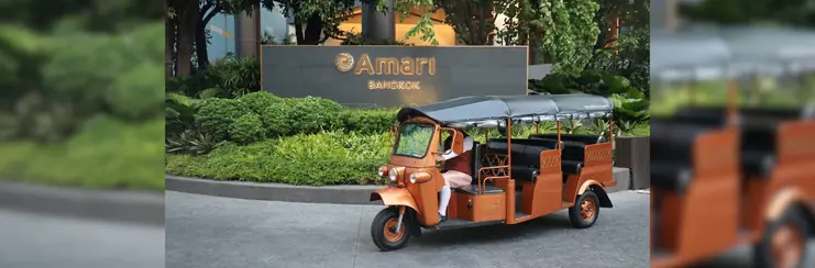 A photo of a tuk-tuk outside of Amari Bangkok sign