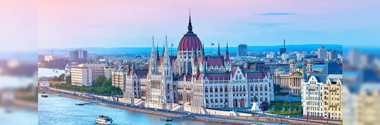 A photo of Budapest on a clear evening on the riverbank