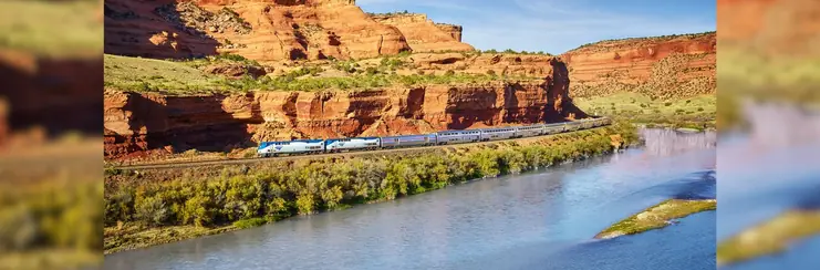 The California Zephyr driving along a desert river valley