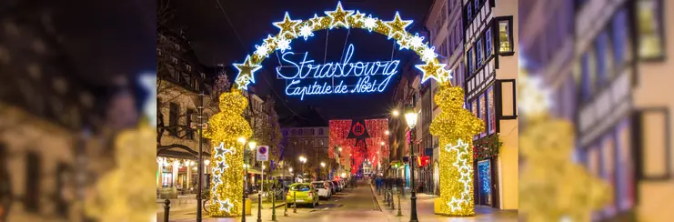 A night-time photo of a Strasbourg christmas arch which reads "Strasbourg, Capitale de Noel"