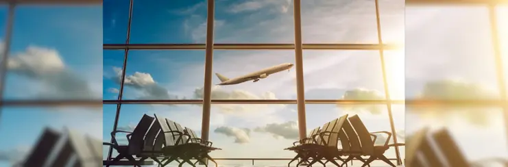 An airplane ascending, seen from a terminal waiting area