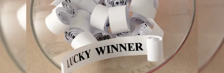a bowl with an unravelled piece of paper that reads 'Lucky Winner'.