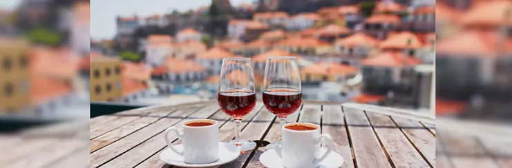 Two glasses of wine on a table with two mochas