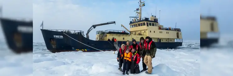 Secret Atlas private charter vessel with a family stood on the ice