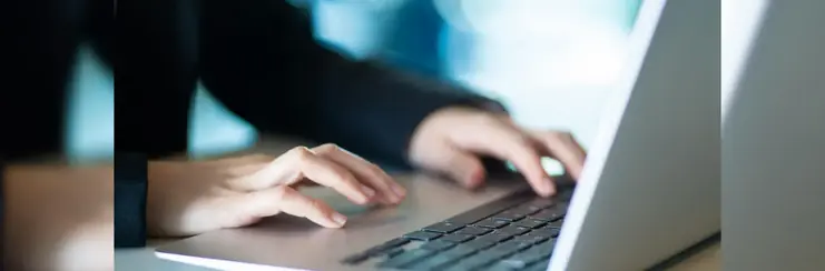 Man typing on a laptop