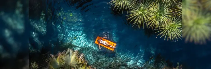 A woman laying on a float in a river