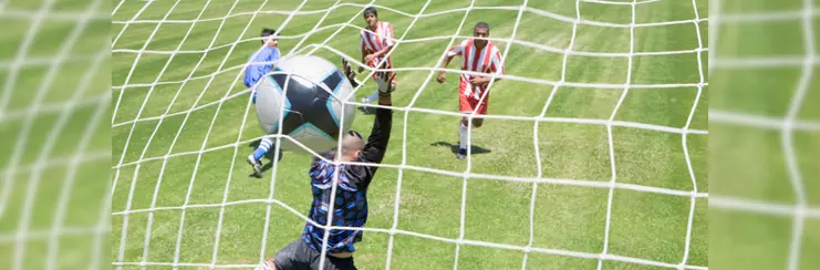 A footballer scoring a goal