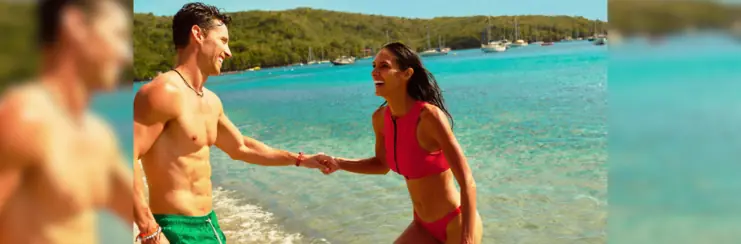 Man and woman on beach holding hands