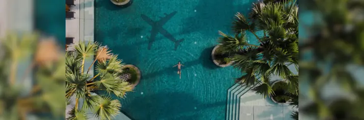 Man in pool with plane shadow