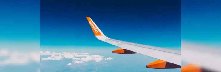 easyJet plane wing in above the clouds