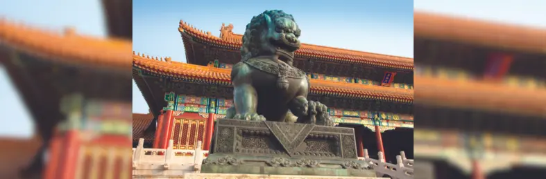 A statue of a dragon outside a traditional Chinese temple.