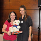 Charlotte Mendoza, Carnival (right) presents Gloria Gilbert, Colletts Travel Limited with a Carnival Teddy and Connect 4 game.