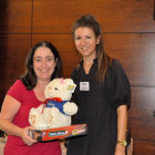 Charlotte Mendoza, Carnival (right) presents Gloria Gilbert, Colletts Travel Limited with a Carnival Teddy and Connect 4 game.