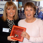 Jeanette Ratcliffe from Travel Bulletin hands a box of chocolates to the lucky Lorinda Webb from Travel Counsellors
