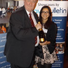 Edward Waite-Roberts (Chandelle Travel) wins a bottle of Champagne with Travel Bulletin?s Tasneem Rahman
